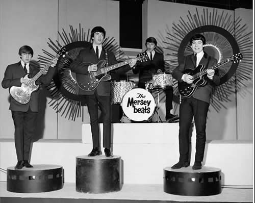 Image may contain: 4 people, people on stage, people standing and people playing musical instruments
